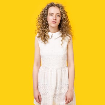 Portrait of a young woman who is tired. Female portrait. Isolated on yellow background