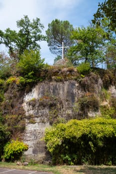 a n empty cross on the top of the chappel mountain of fransiscus from assisi in brive in france