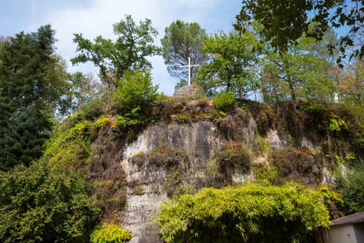 a n empty cross on the top of the chappel mountain of fransiscus from assisi in brive in france