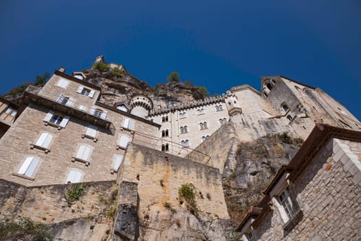 Pilgrimage town of Rocamadour, Episcopal city and sanctuary of the Blessed Virgin Mary, Lot, Midi-Pyrenees, France on a sunny hot day with blue sky
