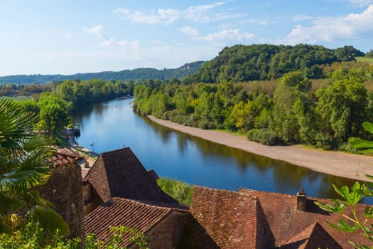 the river dordogne from the la roque gageac with houses in the front and the mountains as background