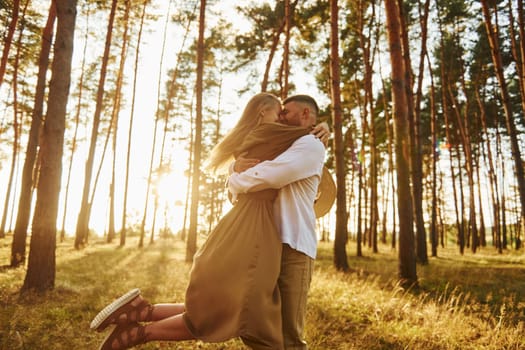 Feeling passion. Happy couple is outdoors in the forest at daytime.