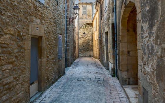 Typical narrow street in the medieval Old Town of Sarlat la Caneda, Perigord, France