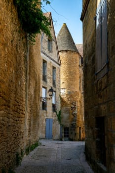 Typical narrow street in the medieval Old Town of Sarlat la Caneda, Perigord, France