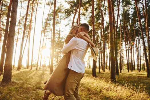 Feeling passion. Happy couple is outdoors in the forest at daytime.