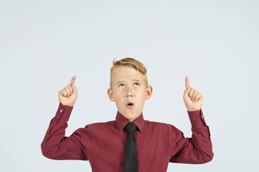 A portrait of a schoolboy showing thumbs up. Education concept.