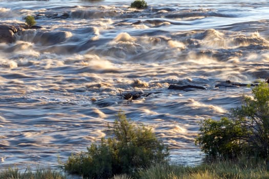 Rapids in the Orange River above the main Augrabies waterfall. The river is in flood