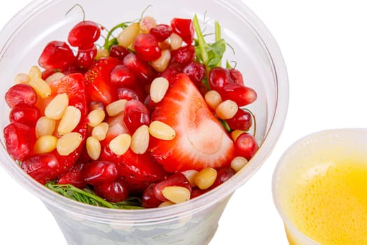 Salad with microgreens, strawberries, pine nuts and pomegranate seeds. Isolated, on a white background. Side view