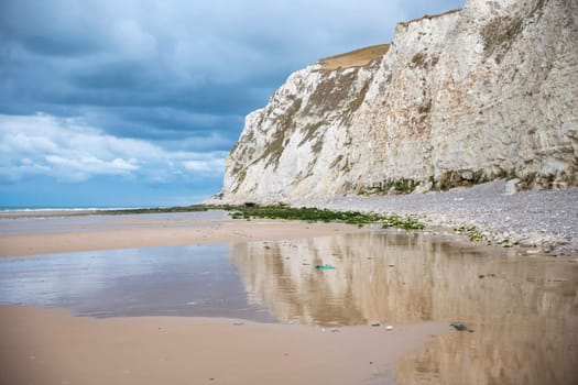 the chalk cliffs of cap blanc nez in france with dark clouds of thunder and rain, part of normandy where the war was fought
