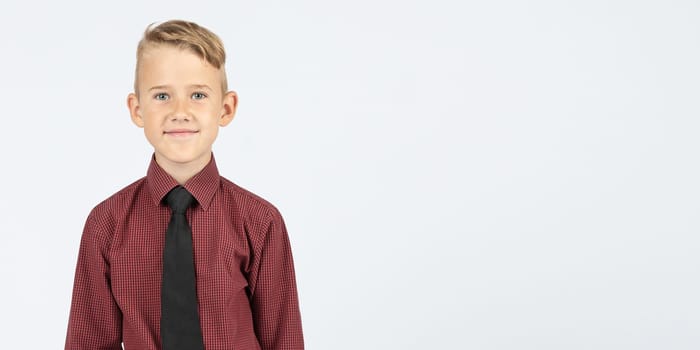 Portrait of a schoolboy looking at the camera. Isolated background. Education concept.