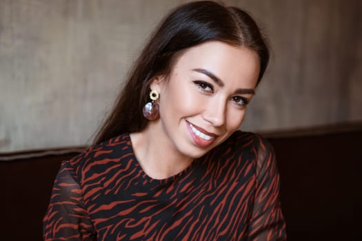 Female beautiful portrait of a brunette Caucasian nationality close-up, beautiful brown eyes with makeup in a young woman