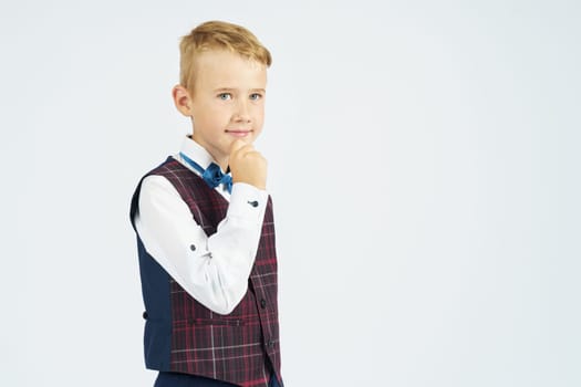 Portrait of a schoolboy looking at the camera. Isolated background. Education concept.