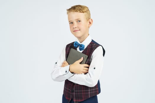 Portrait of a schoolboy looking at the camera. Isolated background. Education concept.