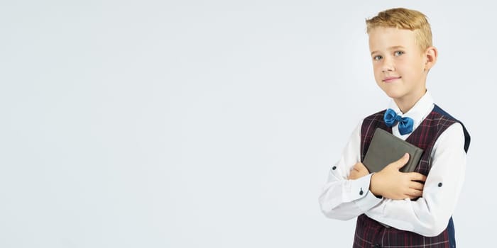 Portrait of a schoolboy looking at the camera. Isolated background. Education concept.