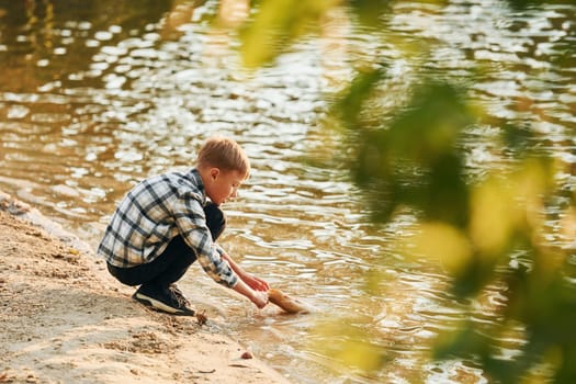 Boy in casual clothes in on fishion outdoors at summertime.