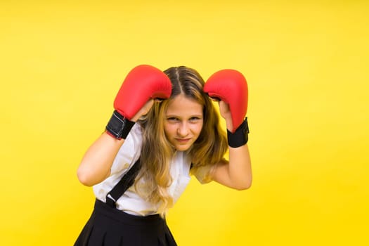 Little girl wearing red boxing gloves, studio shot, sport conception