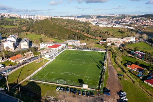 Football field aerial view, public soccer court for training and competition in city.