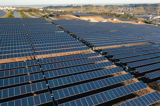 Solar panels on farmland producing renewable source of energy for different houses and companies. Alternative source of energy from sunlight