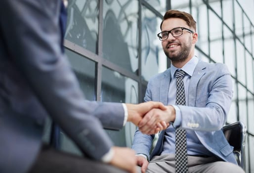 Closeup of business shaking hands over a deal