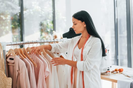 Taking clothes. Seamstress is in her office at daytime.