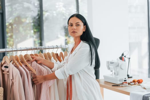 Taking clothes. Seamstress is in her office at daytime.