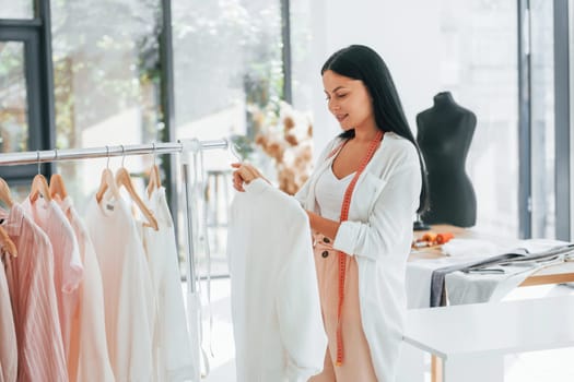 Looking for shirt. Seamstress is in her office that is with different clothes.