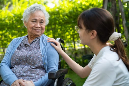 caregiver help and care Asian senior woman patient sitting on wheelchair at nursing hospital ward, healthy strong medical concept.