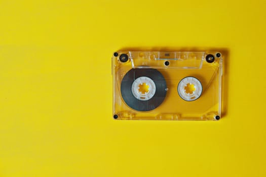 One audio cassette on a yellow background