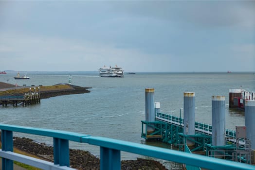 the ferry arrives at the jetty for the crossing from the mainland to the island of Texel in the Netherlands with the horizon and the sea in the background
