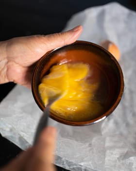 woman hand whisking eggs , top view.