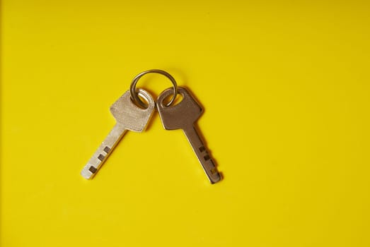 top view of two keys from the lock on a yellow background