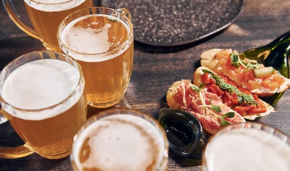 Close up view of food and beer on the table.
