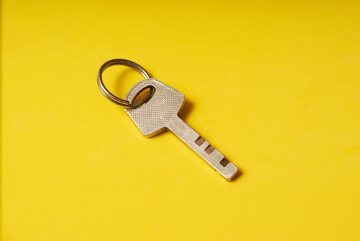 top view of the key from the lock on a yellow background