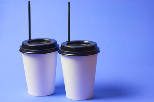 Paper coffee container with Black Lid on blue background white coffee paper cup with black Lid takeaway Coffee