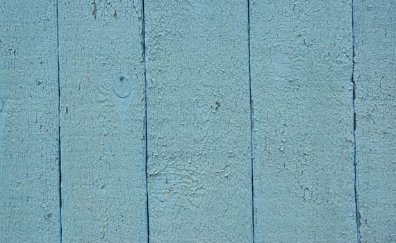 Blue wooden fence Old and dry painted boards. Blue wooden background.