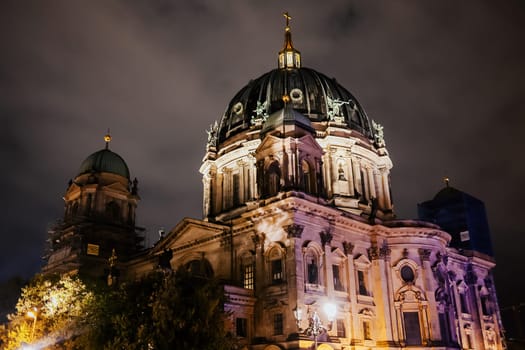 View of Berliner Dom (Berlin Cathedral), monumental German Evangelical church at night. Dramatic sky, travel sightseeing. High quality photo