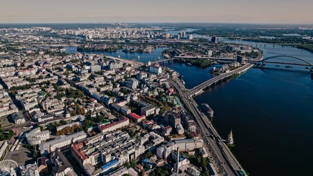 Kyiv, Ukraine - September, 2022: aerial drone view to Dnieper river near Podil. Flight over capital - one of greenest metropolis in Europe. Ecology, nature concept.