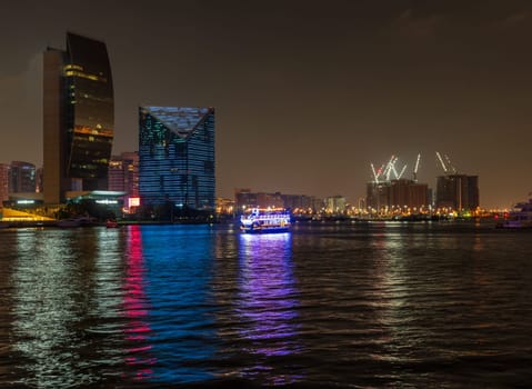 View down the Creek towards Deira as tour boats pass along the water in Dubai, UAE