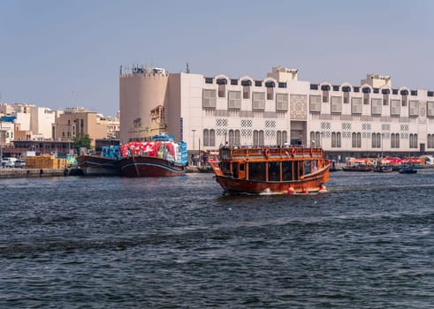 Tourists touring the Creek from Bur Dubai to Deira on a traditional dhow boat