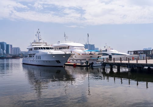 View across the Creek towards Deira with large boats docked in Dubai, UAE