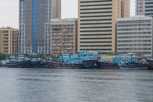 Frieght and cargo dhows docked on the Deira waterfront in Dubai seen across the creek from Bur Dubai