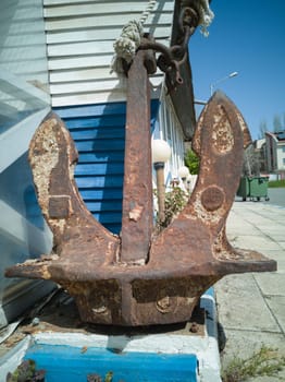 Old abandoned rusty iron ship anchor.