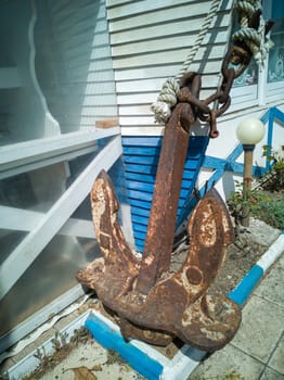 Old abandoned rusty iron ship anchor.