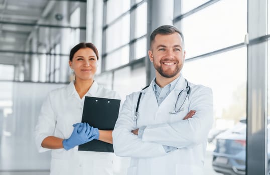 Facial expressions. Two doctors in white coats is in the clinic working together.