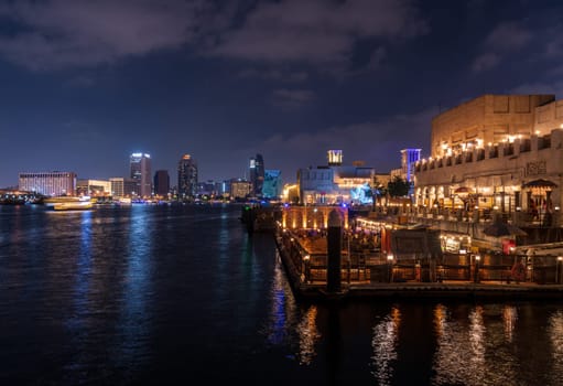 Dubai, UAE - 30 March 2023: View down the Creek towards Deira with waterfront restaurants