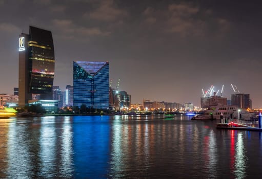 Dubai, UAE - 30 March 2023: View down the Creek towards Deira as tour boats pass along the water