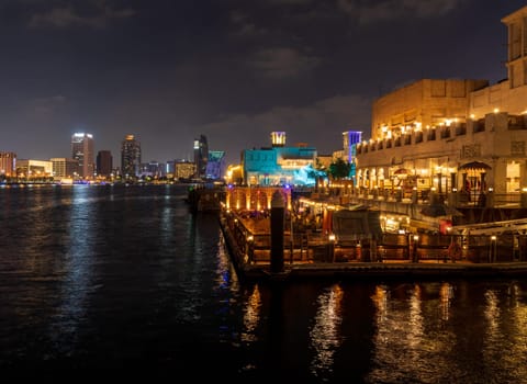 Dubai, UAE - 30 March 2023: View down the Creek towards Deira with waterfront restaurants