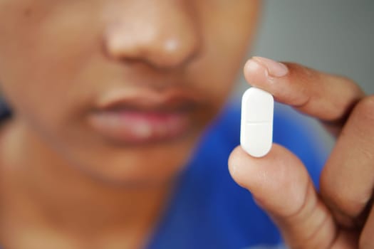 Close up of man hand holding pills with copy space .