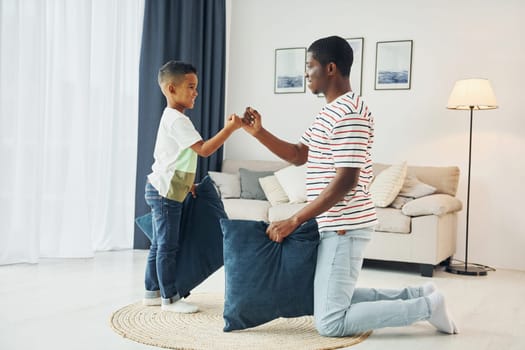 Happy family. African american father with his young son at home.
