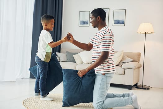 Happy family. African american father with his young son at home.